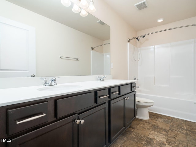 full bath with visible vents, a sink, toilet, and double vanity