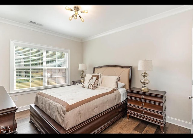 bedroom featuring ornamental molding, wood finished floors, visible vents, and baseboards