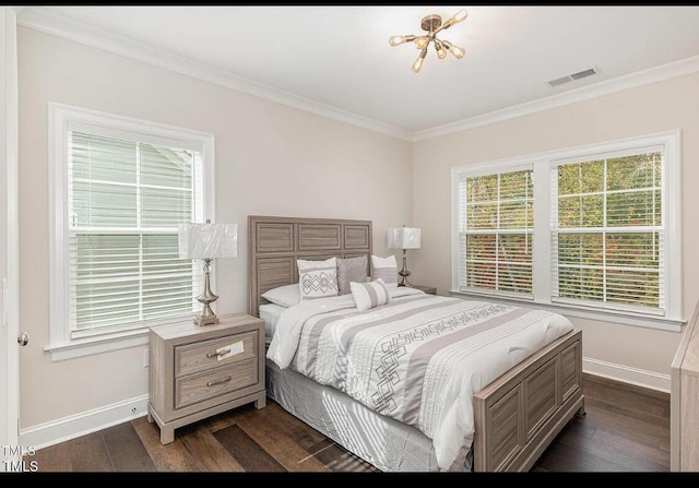 bedroom featuring ornamental molding, visible vents, dark wood finished floors, and baseboards