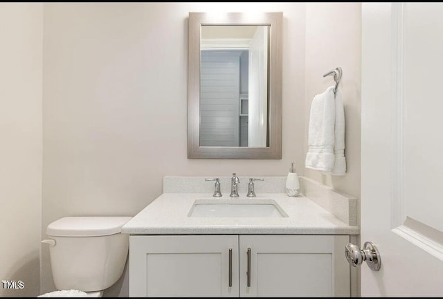 bathroom featuring toilet and vanity