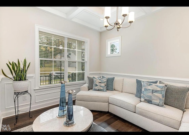 living room with coffered ceiling, a wainscoted wall, dark wood-style flooring, beamed ceiling, and a notable chandelier