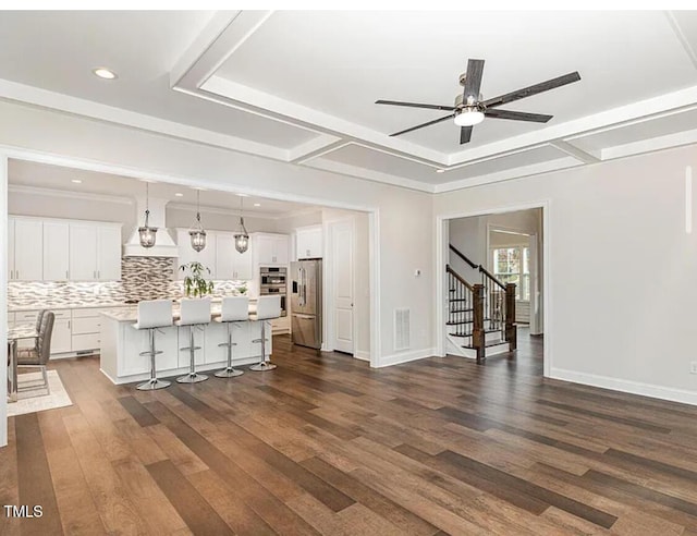 unfurnished living room featuring dark wood-style floors, visible vents, baseboards, and stairs