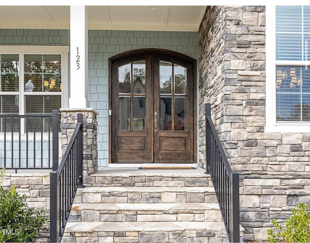 doorway to property with stone siding