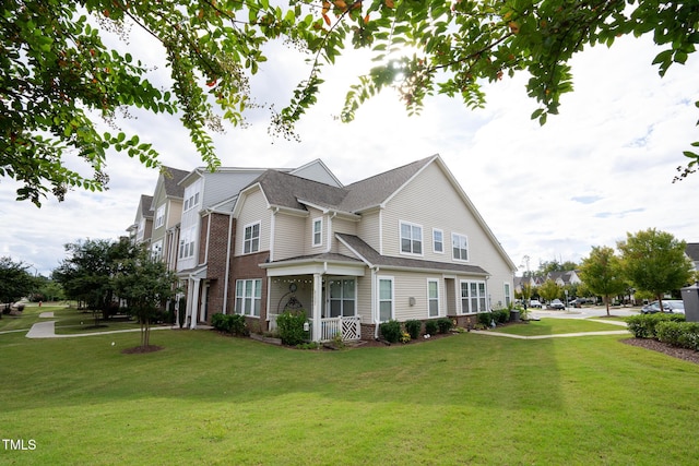 view of front of home with brick siding and a front lawn