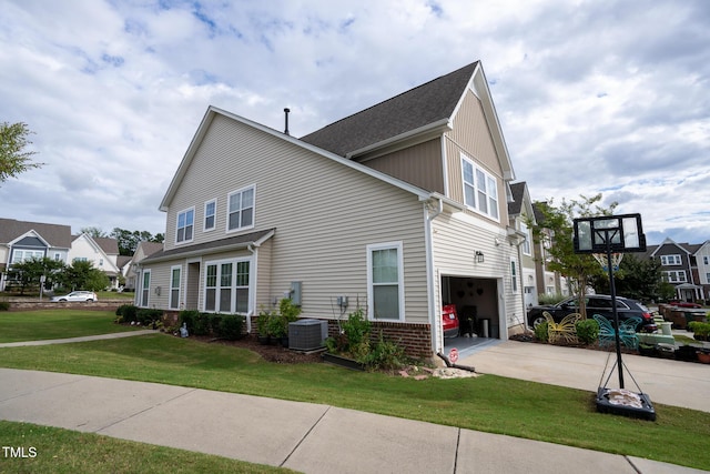 view of property exterior featuring central AC unit, a lawn, concrete driveway, an attached garage, and brick siding