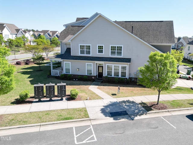 4137 Strendal Dr, Cary, NC 27519 - view of front of house with uncovered parking, roof with shingles, a residential view, and a front yard