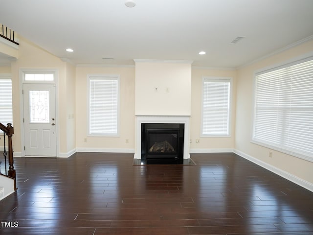4137 Strendal Dr, Cary, NC 27519 - unfurnished living room featuring visible vents, ornamental molding, a fireplace with flush hearth, and wood finished floors