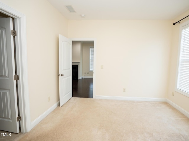 4137 Strendal Dr, Cary, NC 27519 - carpeted spare room with visible vents, baseboards, and a fireplace