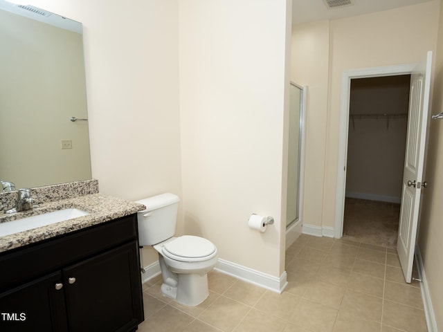 4137 Strendal Dr, Cary, NC 27519 - full bath featuring vanity, tile patterned flooring, toilet, a walk in closet, and a shower stall