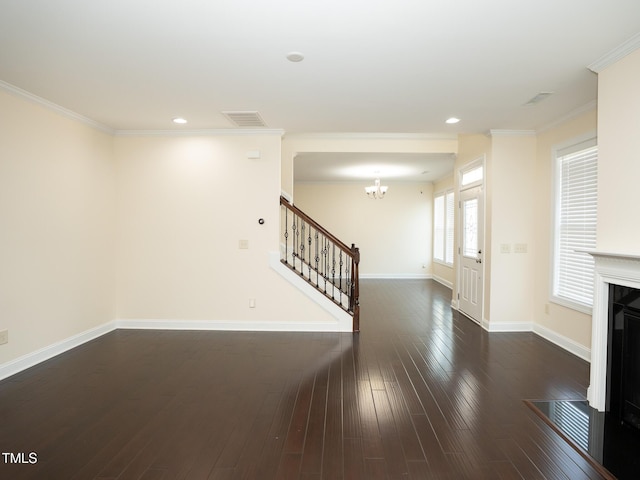 4137 Strendal Dr, Cary, NC 27519 - unfurnished living room featuring visible vents, ornamental molding, dark wood-style flooring, stairway, and a chandelier