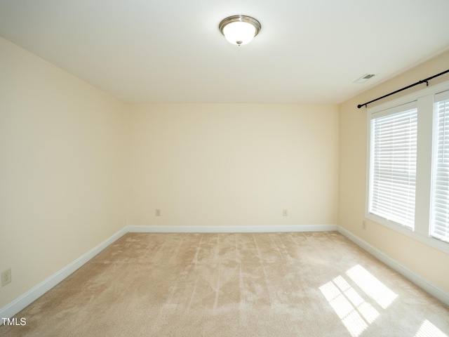 4137 Strendal Dr, Cary, NC 27519 - unfurnished room with baseboards, visible vents, light carpet, and a wealth of natural light