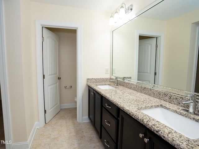 4137 Strendal Dr, Cary, NC 27519 - full bath with double vanity, toilet, baseboards, and a sink