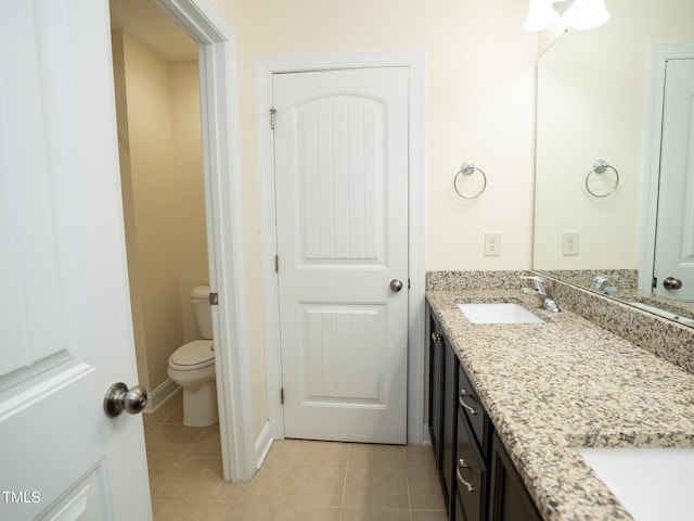4137 Strendal Dr, Cary, NC 27519 - bathroom with double vanity, a sink, tile patterned floors, and toilet