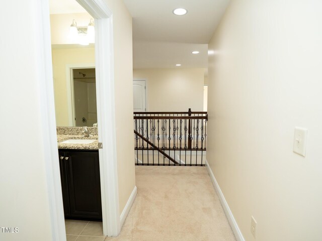 4137 Strendal Dr, Cary, NC 27519 - corridor with baseboards, light colored carpet, recessed lighting, a sink, and an upstairs landing
