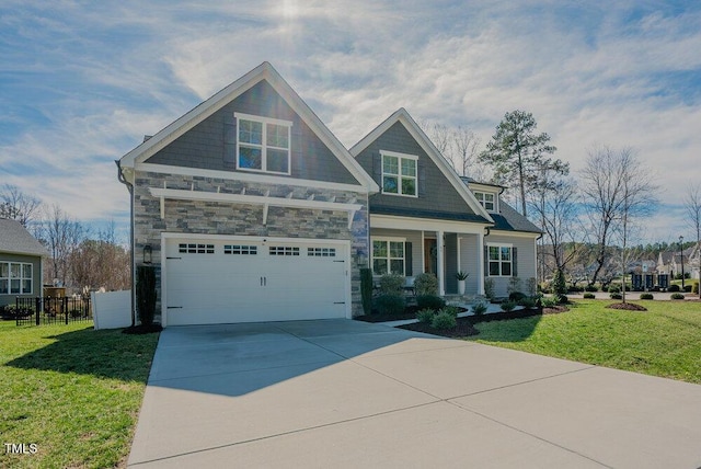 craftsman-style house featuring a front yard, fence, a garage, stone siding, and driveway