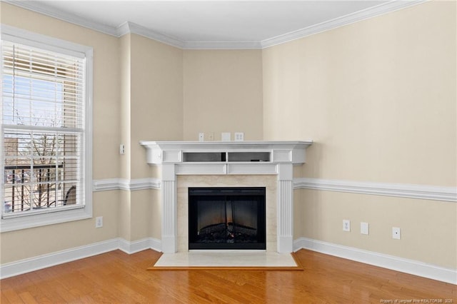 room details with crown molding, baseboards, wood finished floors, and a fireplace with flush hearth