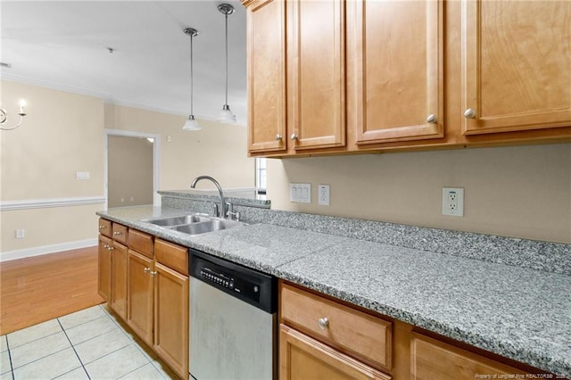 kitchen with pendant lighting, crown molding, light tile patterned flooring, a sink, and dishwasher