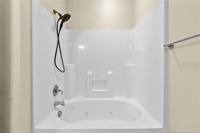 bathroom with a combined bath / shower with jetted tub