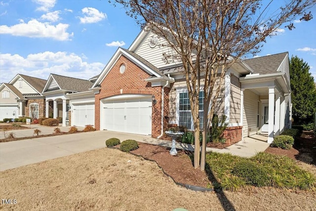 traditional home with brick siding, an attached garage, and driveway