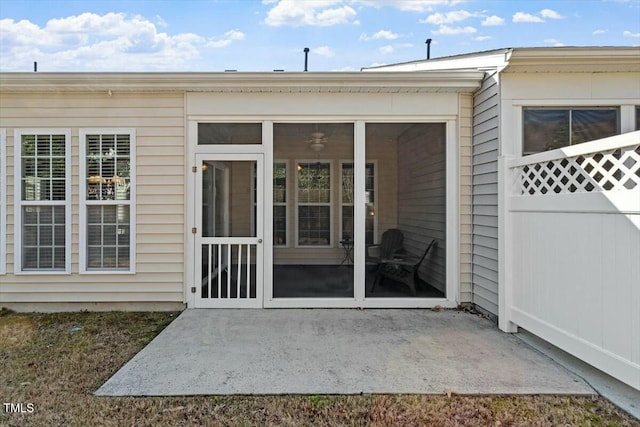 property entrance featuring a patio area and fence