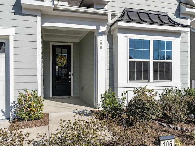 view of exterior entry with a standing seam roof