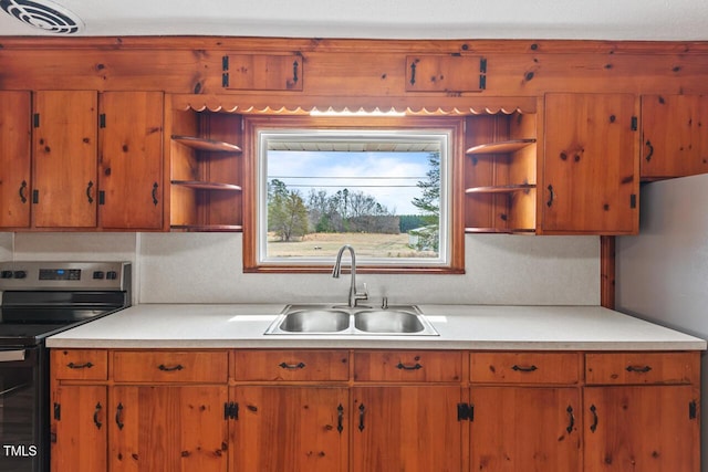 kitchen with stainless steel appliances, a sink, visible vents, light countertops, and open shelves