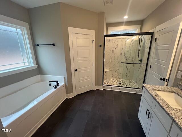 full bath featuring visible vents, a garden tub, wood finished floors, a marble finish shower, and vanity