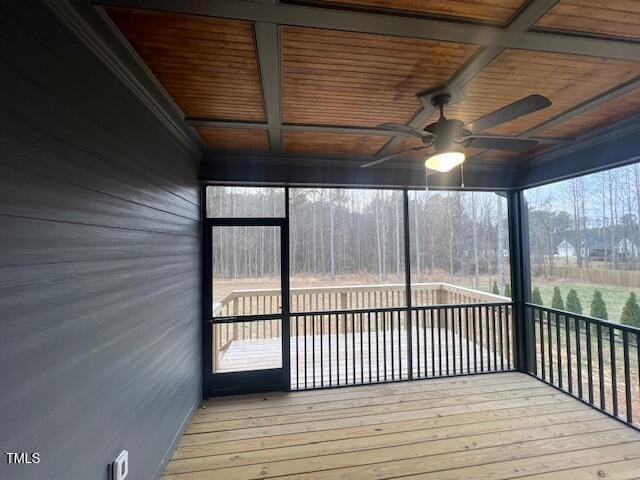 unfurnished sunroom with beam ceiling, coffered ceiling, wooden ceiling, and a ceiling fan