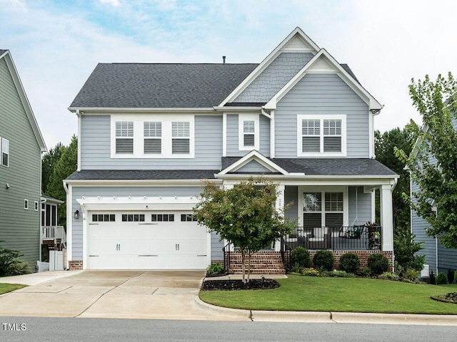 craftsman inspired home featuring driveway, a shingled roof, an attached garage, a porch, and a front yard