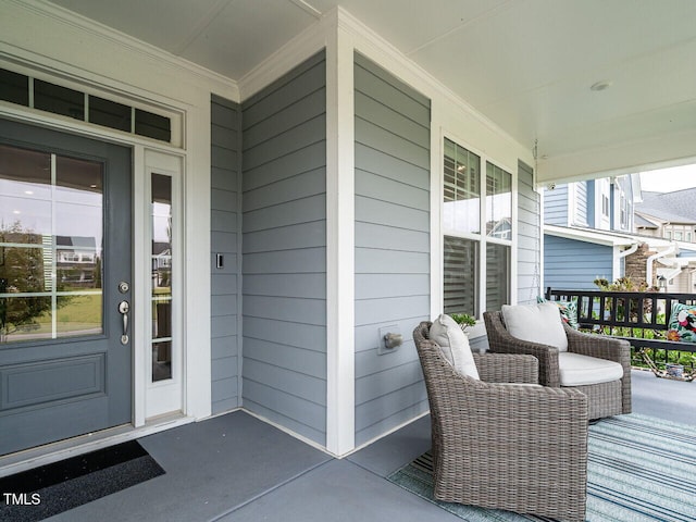 view of exterior entry featuring covered porch