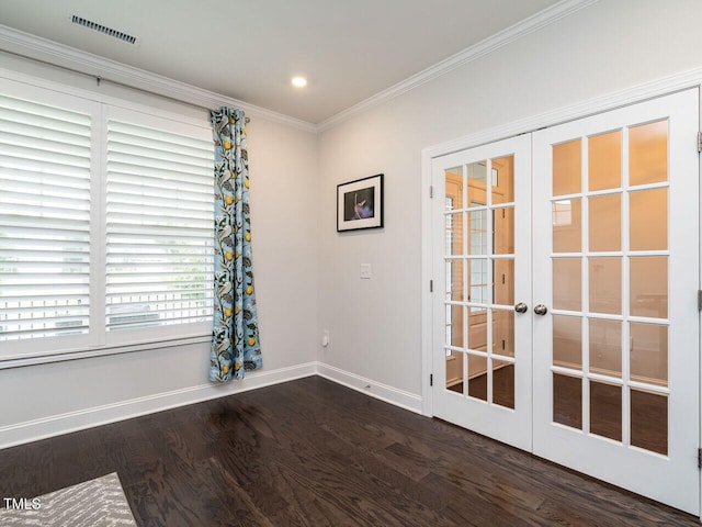 unfurnished room with baseboards, visible vents, dark wood-style floors, crown molding, and french doors