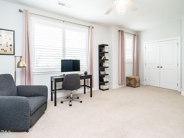 carpeted office space with a ceiling fan, visible vents, and baseboards