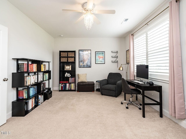 carpeted office featuring a ceiling fan, visible vents, and baseboards