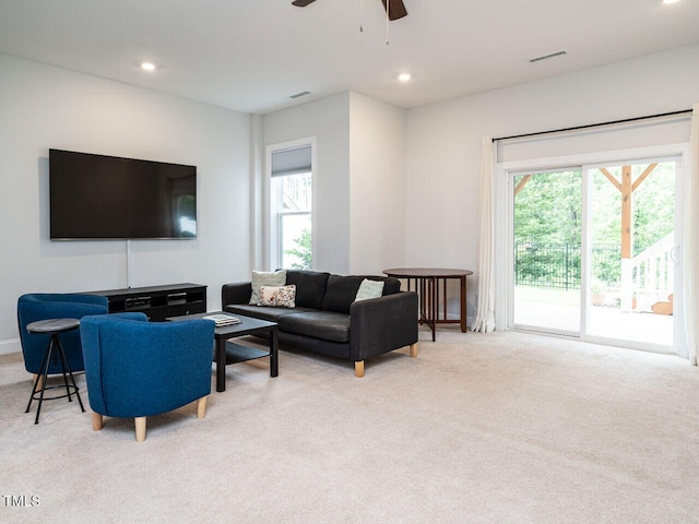 carpeted living room with ceiling fan, visible vents, and recessed lighting