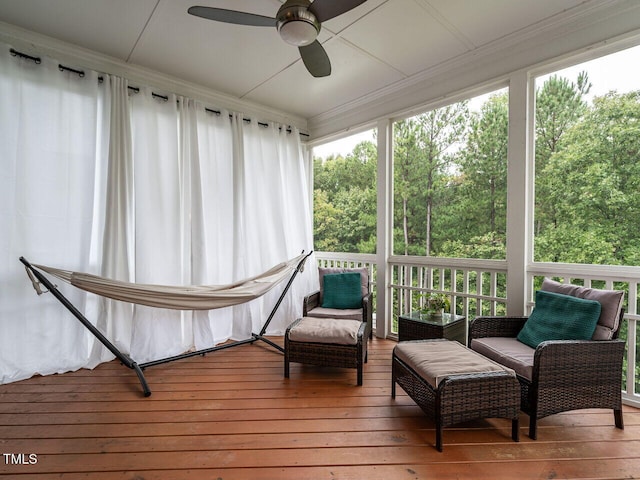 sunroom / solarium with a ceiling fan