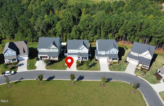 birds eye view of property with a residential view and a wooded view