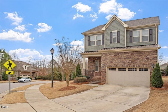 craftsman inspired home with brick siding, a standing seam roof, metal roof, a garage, and driveway