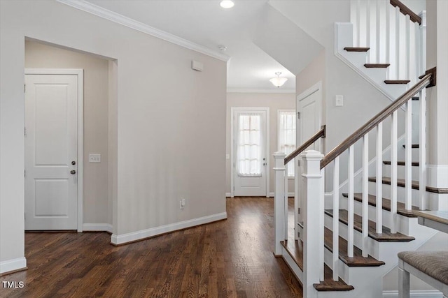 entryway with stairs, crown molding, baseboards, and wood finished floors