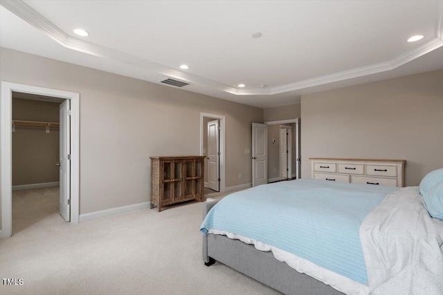 bedroom with recessed lighting, a raised ceiling, light colored carpet, visible vents, and baseboards