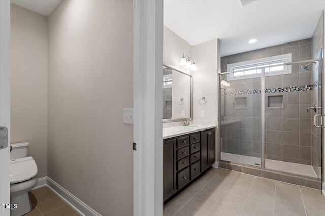 full bath featuring tile patterned flooring, toilet, a sink, baseboards, and a shower stall