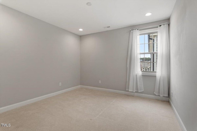 empty room featuring recessed lighting, visible vents, baseboards, and light colored carpet