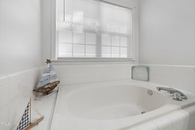 bathroom with a garden tub and a wealth of natural light