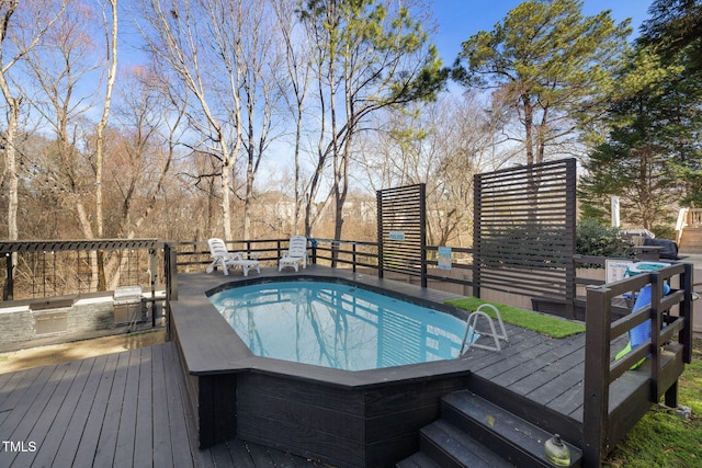 view of pool featuring a hot tub, a deck, and an outdoor kitchen