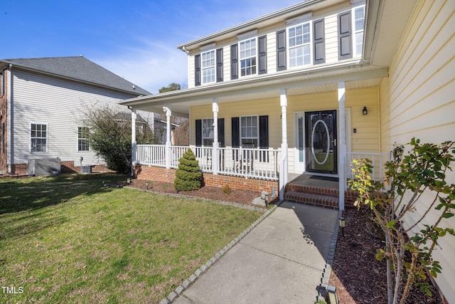 view of front of house with a porch and a front yard