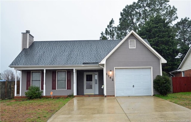 view of front of house with an attached garage, fence, driveway, roof with shingles, and a chimney