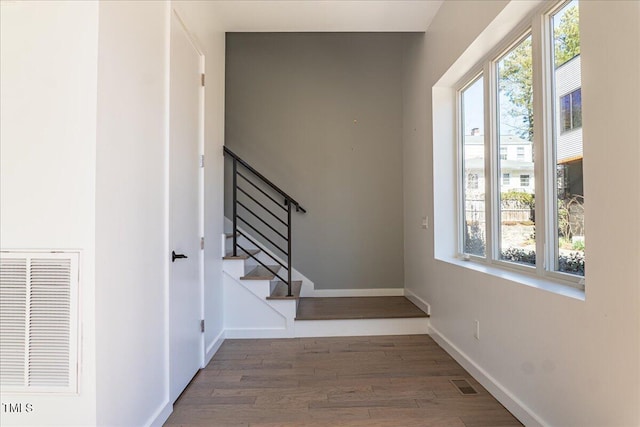 interior space featuring plenty of natural light, visible vents, and wood finished floors