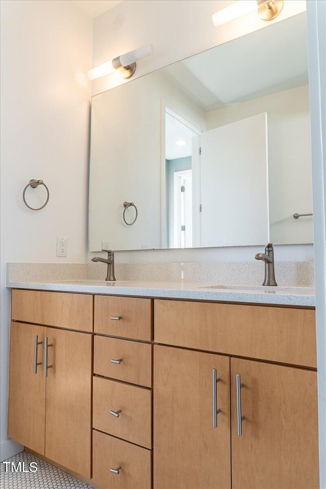 full bathroom featuring a sink and double vanity