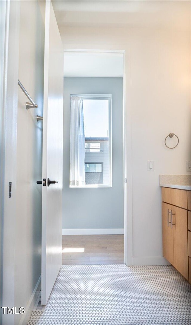 bathroom with vanity and baseboards