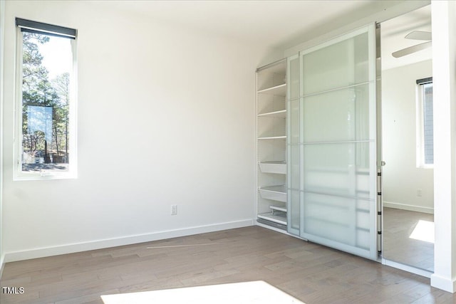 interior space featuring baseboards and wood finished floors