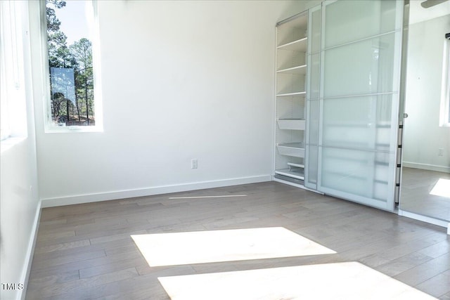 unfurnished bedroom featuring baseboards and wood finished floors